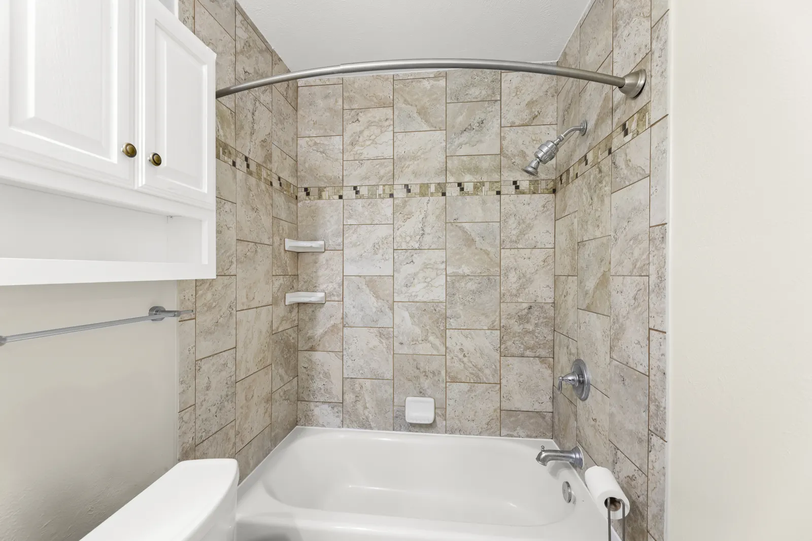 Bathroom with tiled tub and shower